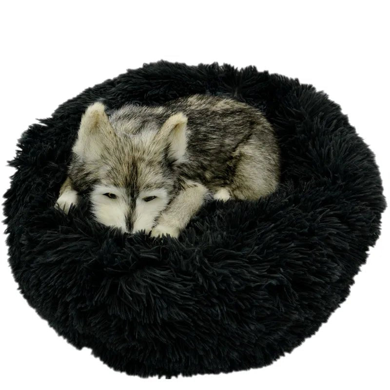 Soft, plush calming donut pet bed for dogs and cats, designed to reduce anxiety with ultra-soft, washable material.