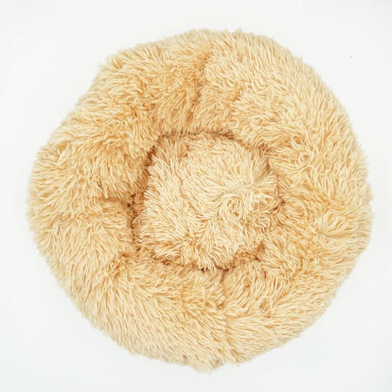 Ultra-soft Calming Donut Pet Bed for dogs and cats, plush, washable, designed to reduce anxiety and provide cozy comfort.