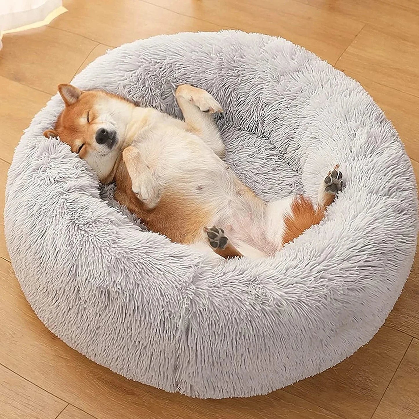 Ultra-soft donut pet bed with plush fabric and raised edges, ideal for dogs and cats seeking comfort and relaxation.