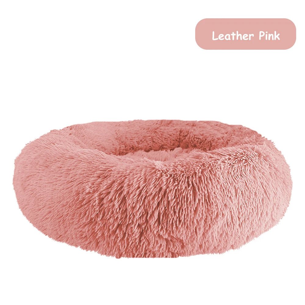 Ultra-soft donut pet bed with plush fabric and raised edges, ideal for dogs and cats, providing comfort and a calming resting spot.